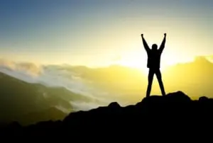 hadrian me Robert standing on a mountain top with hands in the air