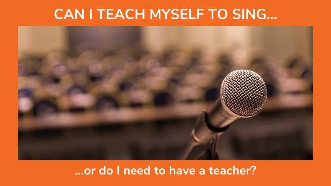 I microphone in front of an audience of empty seats reflects the blog title, "Can I teach myself to sing?"